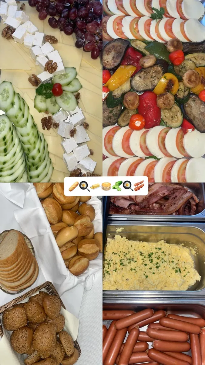 Frühstücksbuffet mit Käse, gegrilltem Gemüse und Brötchen
